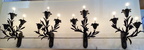 Lillies and leaves gracefully adorn the set of four wall sconces with three electrified "candle" lights each. Ready to mount as unique lighting additions to your home.