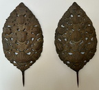 Pair of antique European repousse sconce backs with decorative sunflower detail. The labor intensive metal-working process involves shaping the metal from the back to create the raised intricate design on the front. Each measures 28" high x 14" wide x 2" 