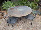 Large Round Iron Patio Table and 4 Chairs. Table easily seats six comfortably.